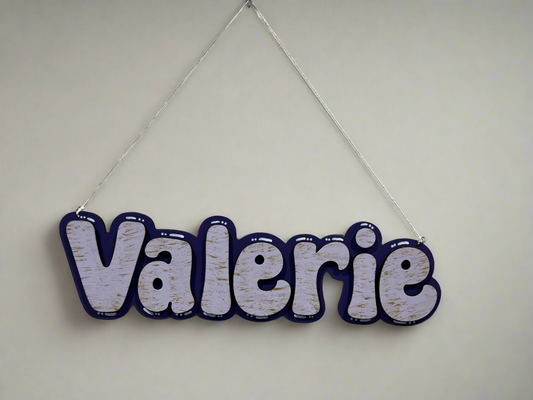 Customizable name sign with name "Valerie", decorated with many materials. (Paint pens, glitter paint, etc)