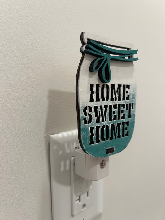 Decorative wall plug-in, mason jar shaped, ombre paint (white to teal) and "home sweet home" text punched out of material.