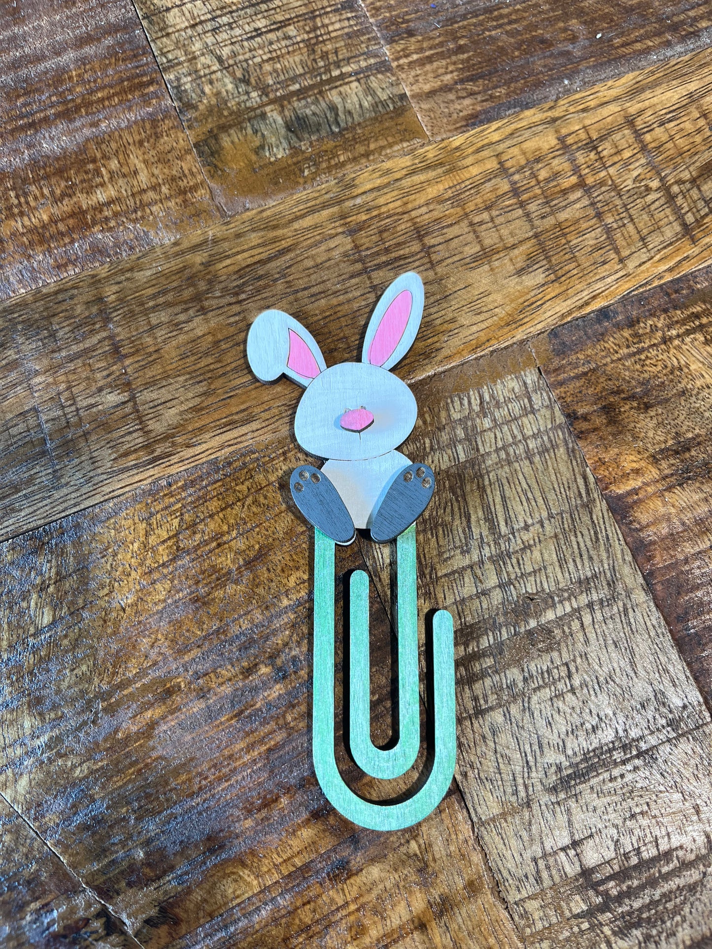 Bunny-shaped book mark on a wooden surface