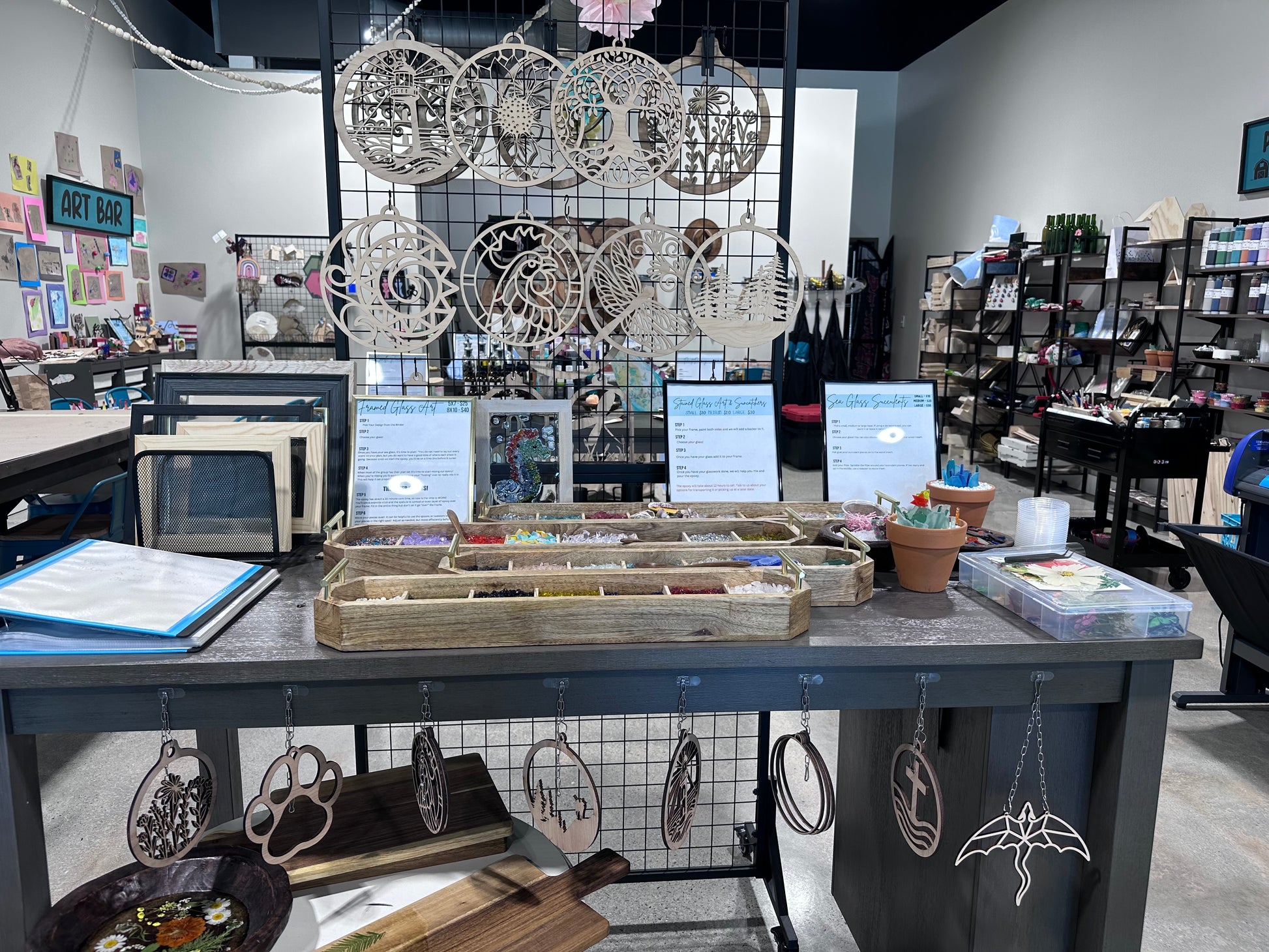 Display of window glass art supplies like frames, gems, tweezers, design options, etc.