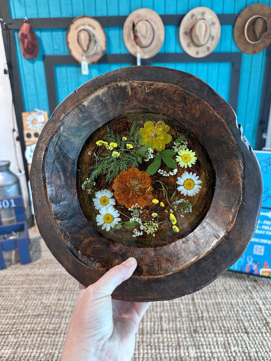 Close up of dough bowl with flowers; summery colors and greenery.