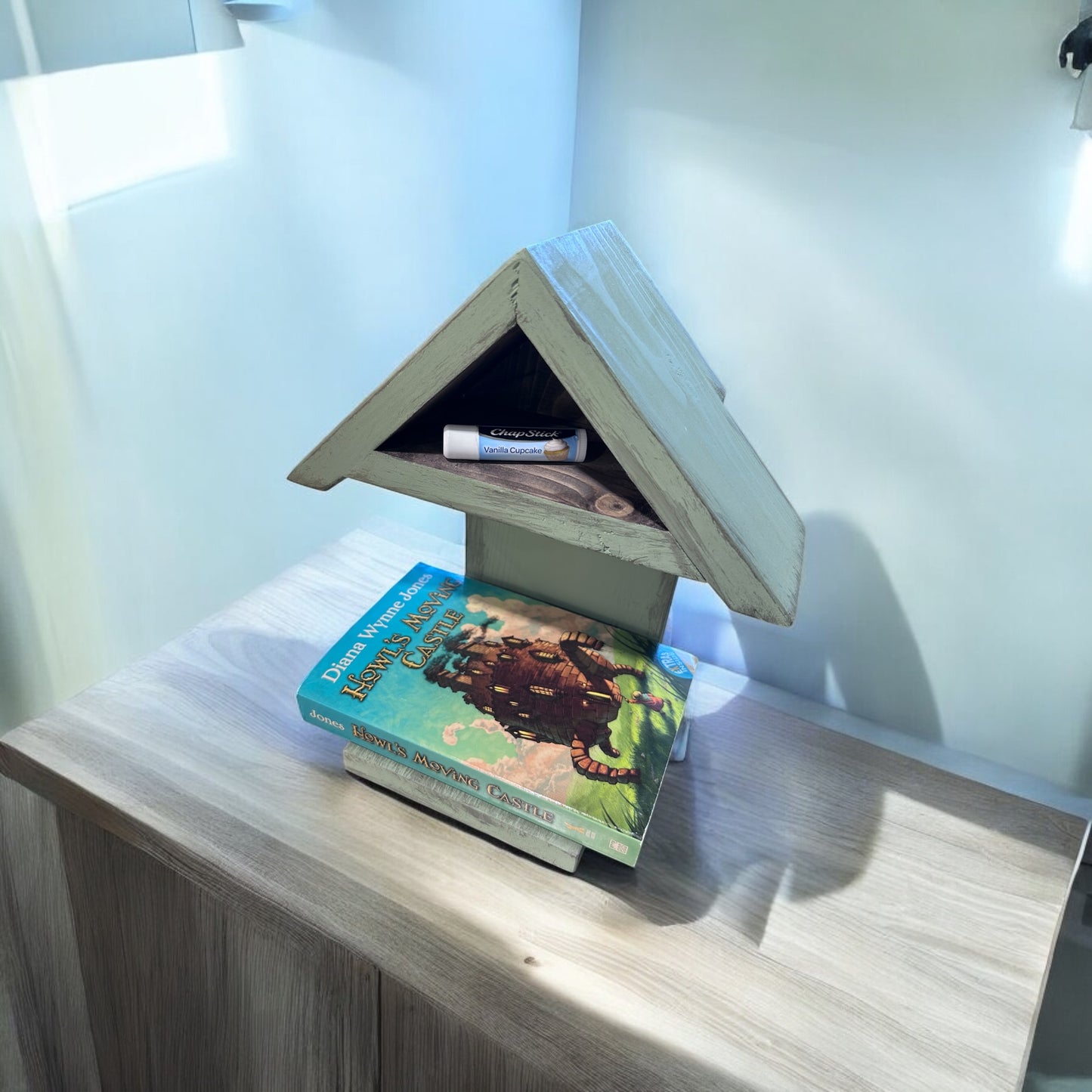 Book holder featuring chapstick holder and cute farmhouse shape.