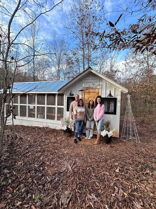 Eric and Valerie Anderson along with their daughters at their recently built chicken coop.