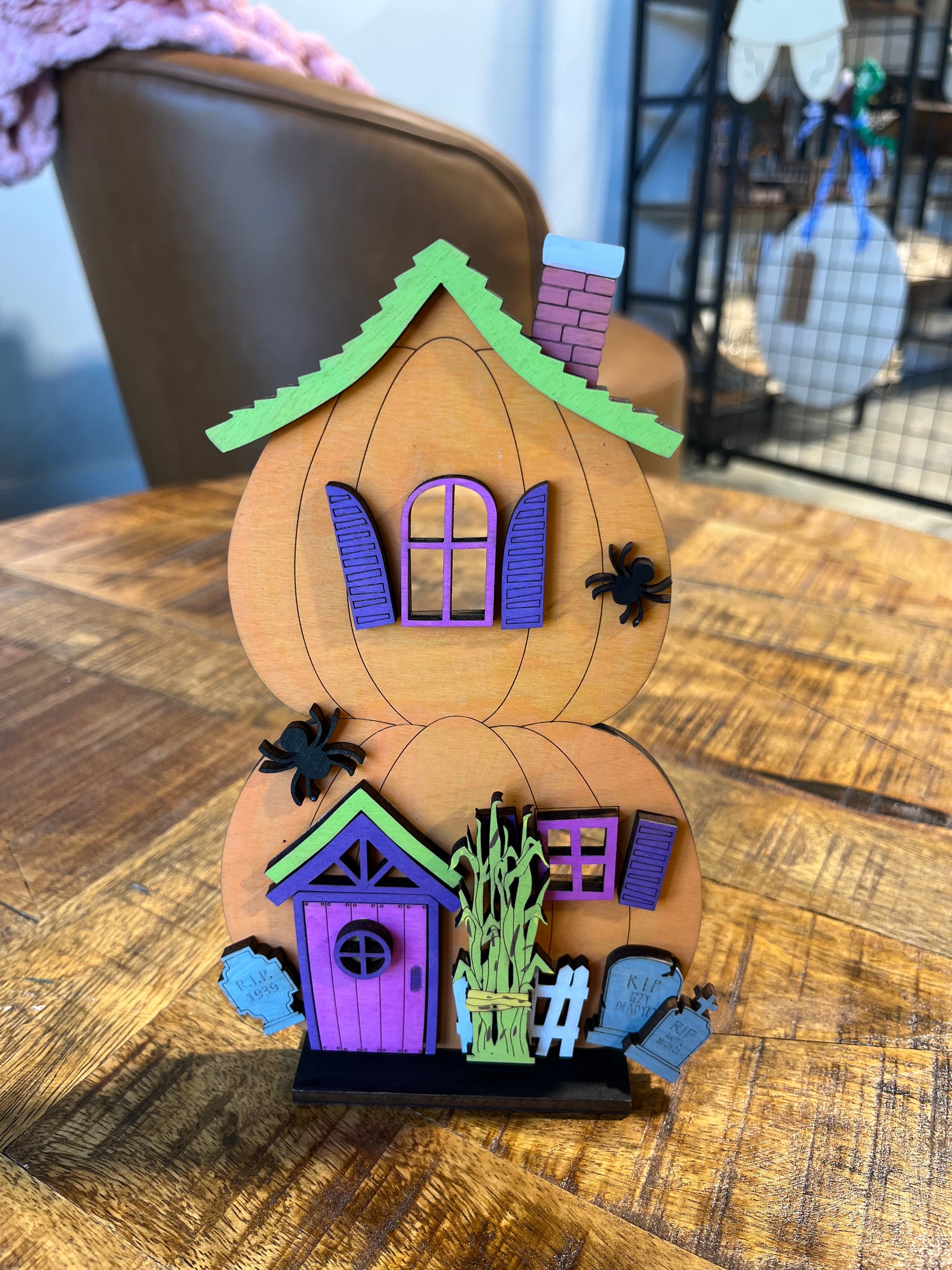 Stacked pumpkin shaped spooky house shelf decor