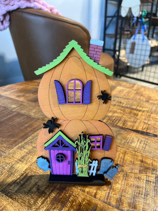Stacked pumpkin shaped spooky house shelf decor