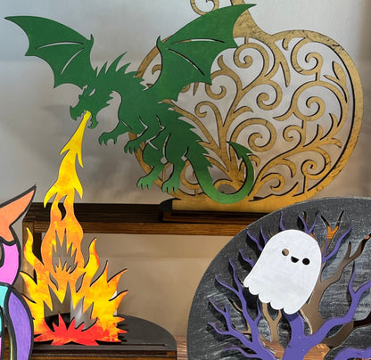 Green dragon painted on laser cutout birch plywood with backlit batterst operated votive candle for shelf decor