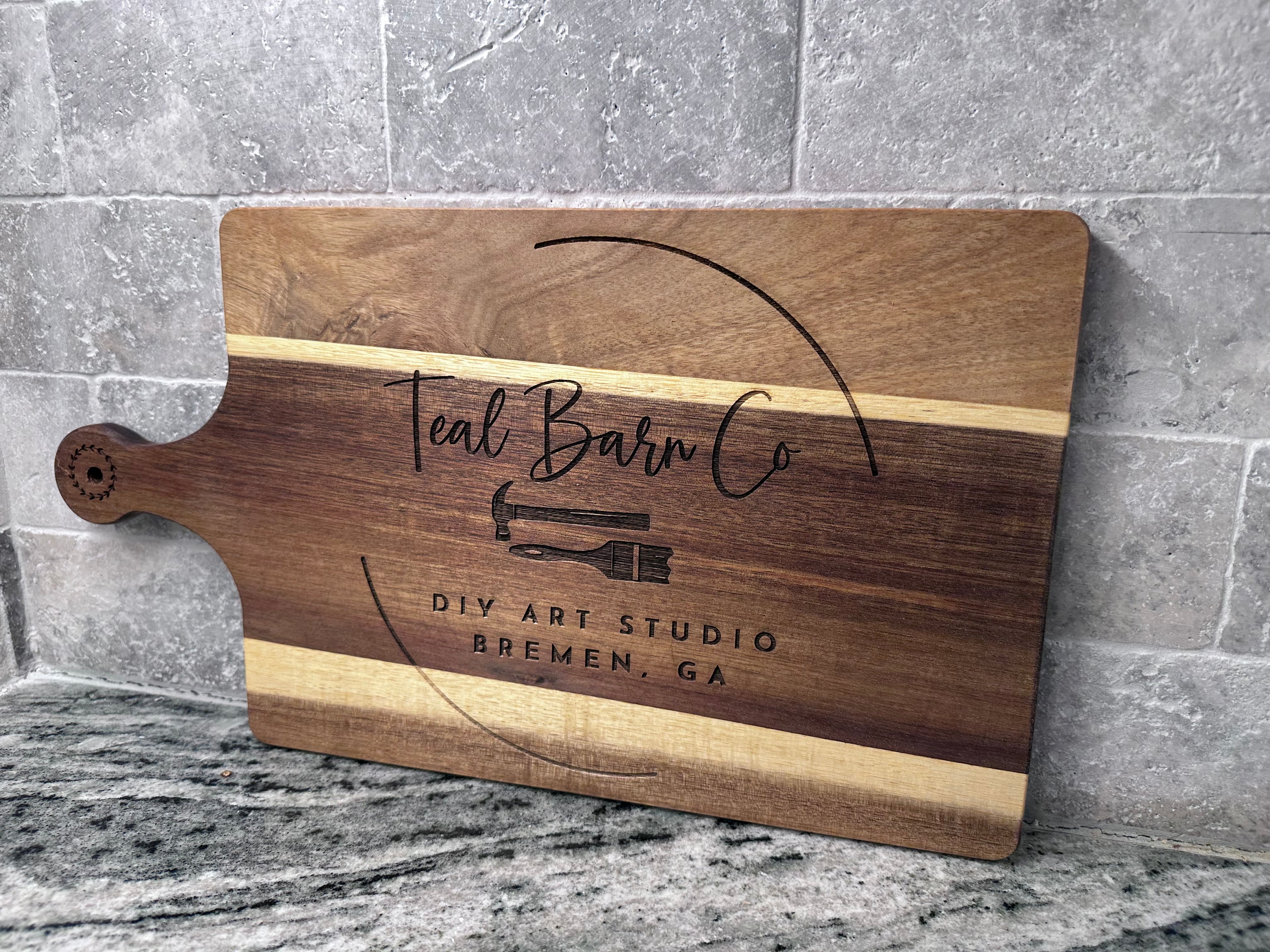 Wooden cutting board with 'Teal Barn Co' custom engraved on the front