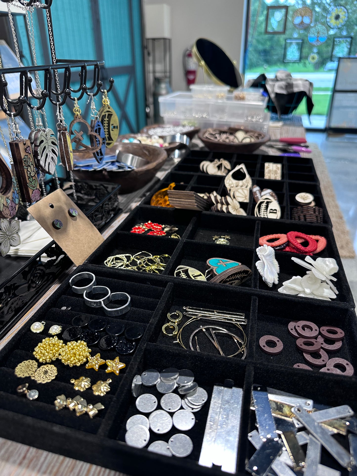 Jewelry display including laser cut, acrylic, customizable, and silver/gold charms.