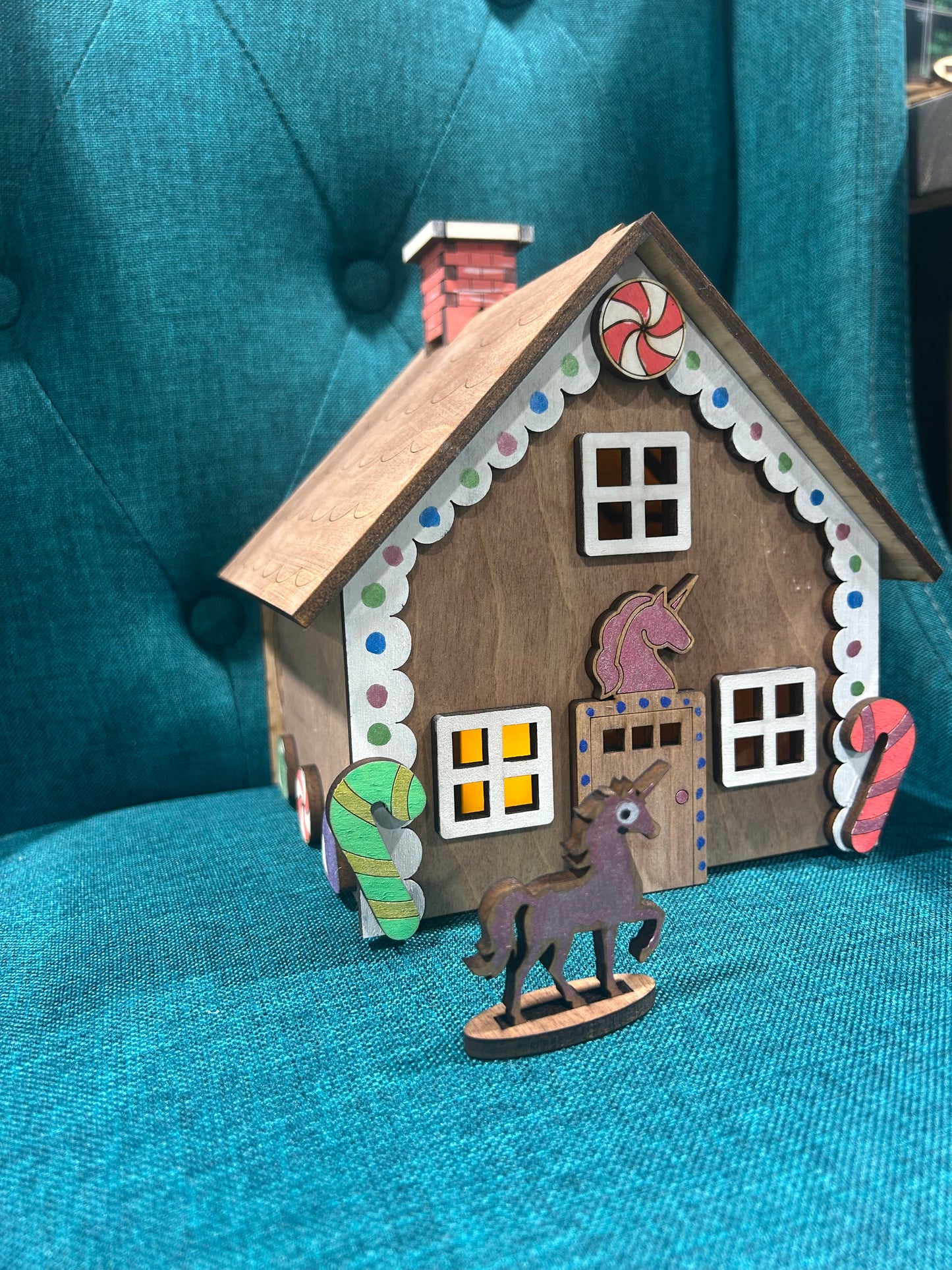 Laser cut gingerbread house featuring unicorn figure