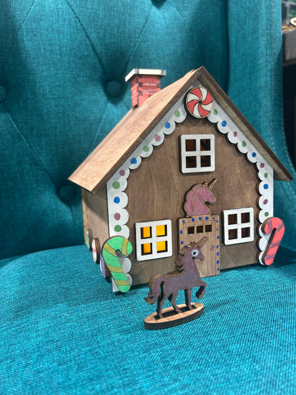 Laser cut gingerbread house featuring unicorn figure