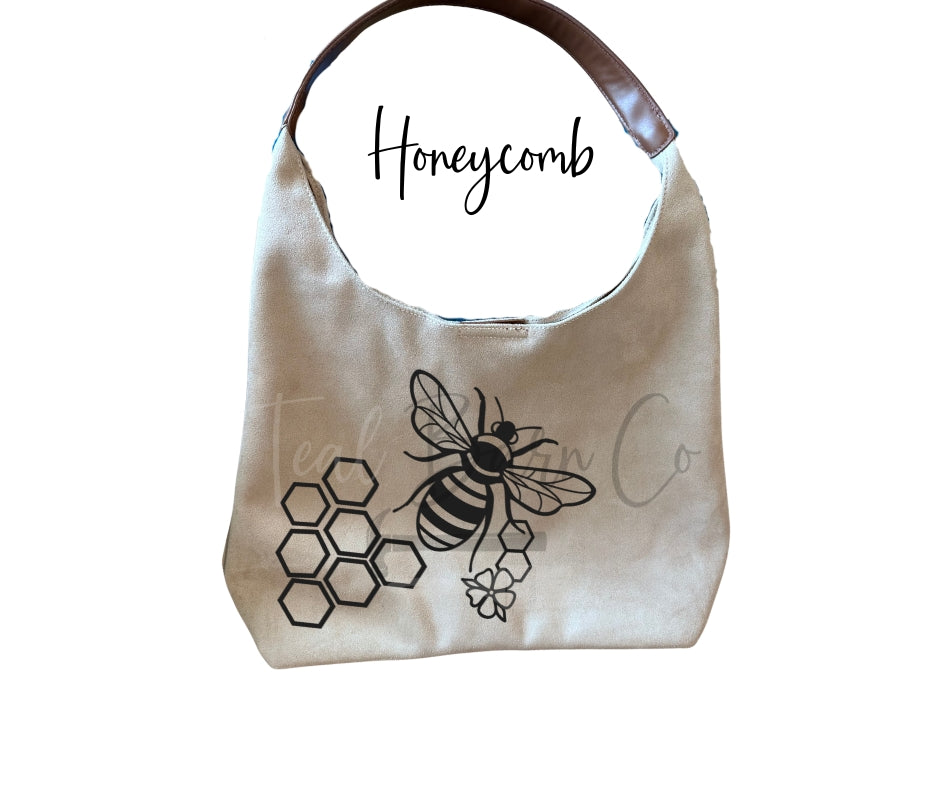 pyrography workshop featuring a variety of designs. Honeycomb and bee design can be hand burned into your suede bag