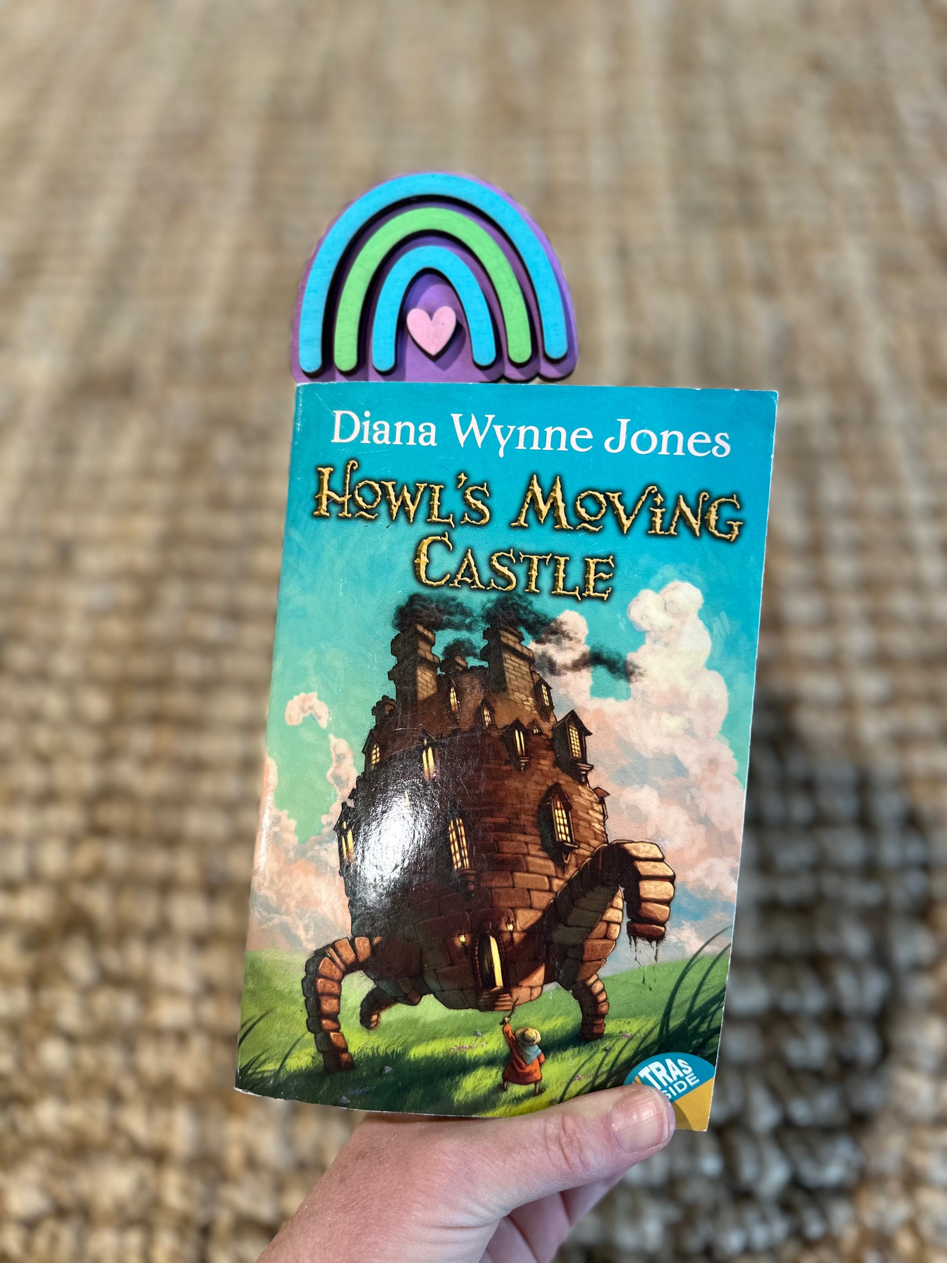 Rainbow bookmark shown in a book.